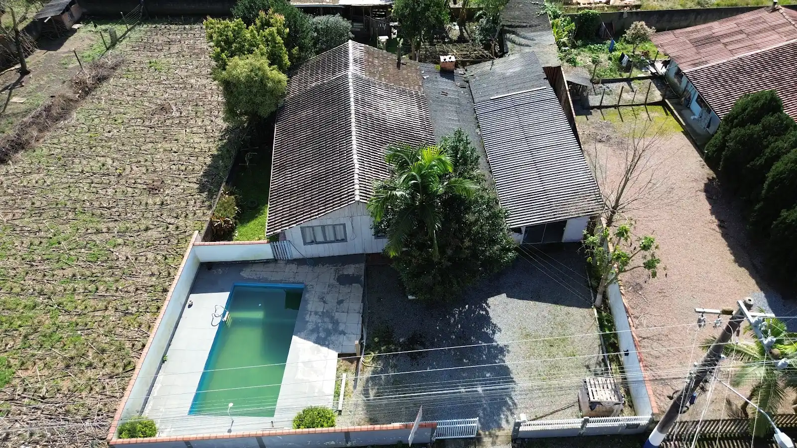 Vista superior da casa, da garagem e da piscina de alvenaria