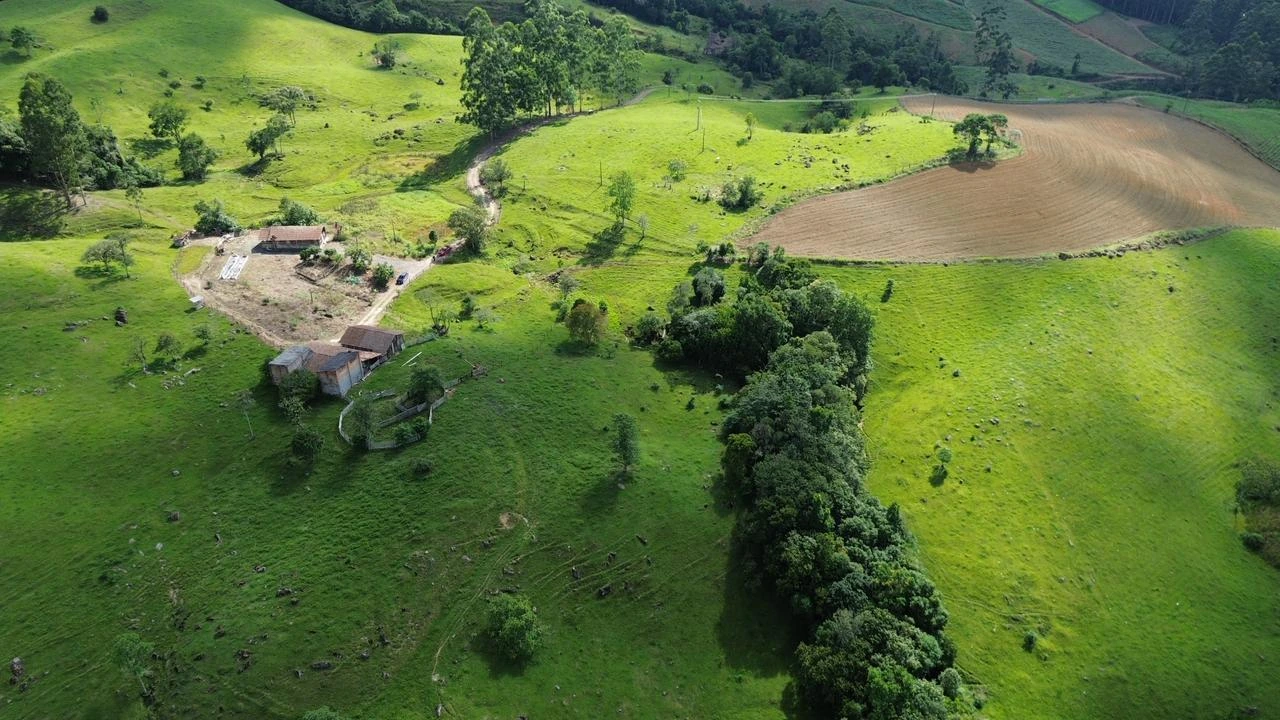 Vista ampla do campo, das construções e do relevo